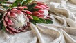 proteas on a white damask cloth with space for text