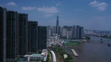 Ho Chi Minh City, Saigon River And Binh Thanh Skyline On Sunny, Clear Day Featuring Landmark Building From Drone Crane Shot.
