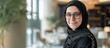 © MUCHIB - Portrait of business muslim woman wearing hijab inside office with laptop. AI generated image