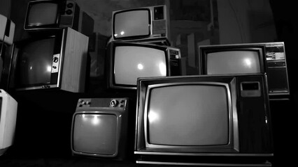 Wall Mural - an old tv turning on green screen among many retro tvs. aesthetics of the 80s and 90s. black and whi