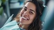 © Oleksandr Kozak - Portrait of happy young woman with healthy smile sitting in dental chair in dentistry