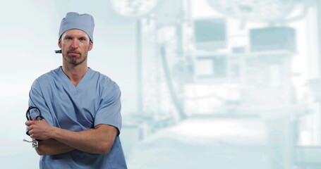 Canvas Print - Image of portrait of male doctor holding stethoscope over out of focus hospital