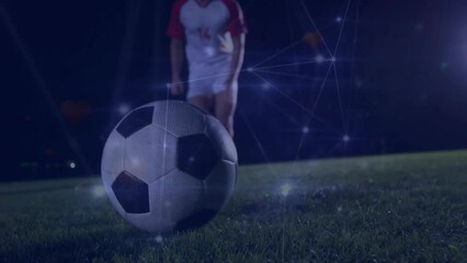 Wall Mural - animation of network of connections over caucasian male football player kicking ball on field