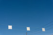blue sky dotted with overhead traffic signs (verso side)