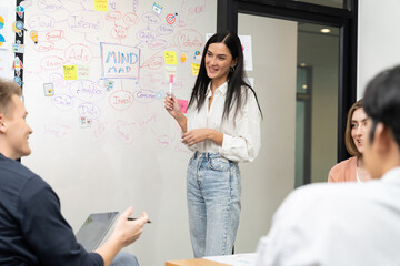 Wall Mural - Young beautiful leader presents marketing strategy while expert investor and project manager lecturing to analyze business performance at start up business meeting. Multiethnic group. Immaculate.
