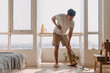 Asian Thai man using mop for cleaning floor in living room apartment, Man do household chores, housework concept. marriage life.