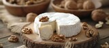 Fototapeta  - Delicious piece of cheese with assorted nuts on a rustic wooden table