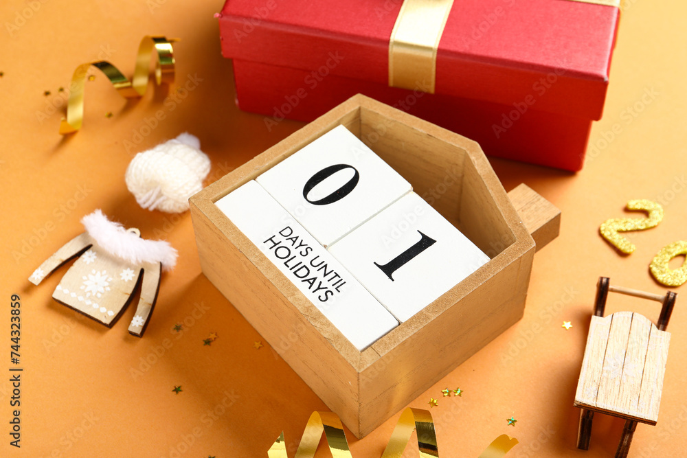 Countdown calendar with Christmas decorations and gift box on orange background