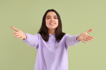 Sticker - Beautiful young happy woman opening arms for hug on green background