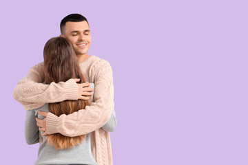 Sticker - Young couple hugging on lilac background