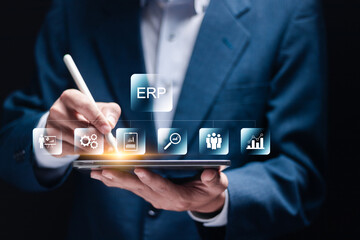 Wall Mural - Enterprise Resource Planning concept. Connections between business intelligence, production, HR and CRM modules. Businessman use tablet to analyzing ERP system on virtual screen.