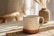 Warm morning sunlight spills over a speckled ceramic mug of coffee, resting on the table.