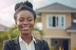 Portrait of smiling african american female real estate agent in front of house
