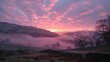 A stunning sunrise over a misty, fog-covered valley, painting the sky in hues of pink and orange as the morning light breaks through.