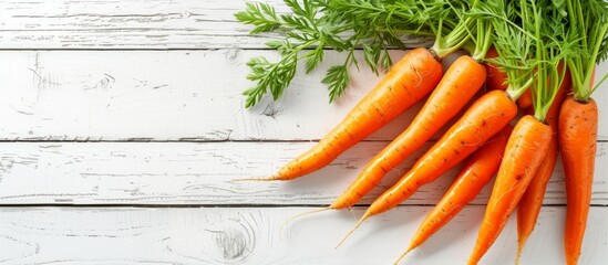 Poster - Fresh organic carrots on a rustic white wooden surface ready for cooking