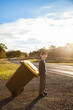 © Austockphoto - Young boy doing job taking bin across the road