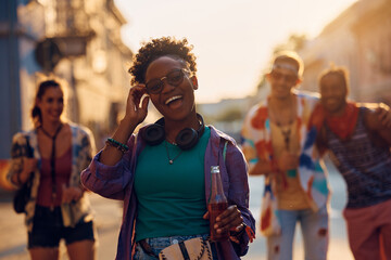 Wall Mural - Cheerful black woman having fun while going with friends on summer music festival.