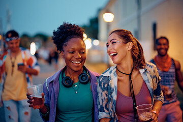 Wall Mural - Young happy women having fun on music concert in summer.