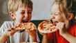 © Yulya - The kids' uncontainable excitement for their pizza is evident as they eagerly relish the flavors with every bite.