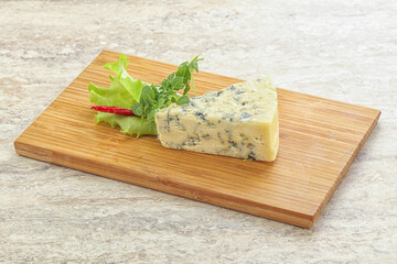 Wall Mural - Blue cheese piece over board