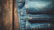 Jeans stacked on a wooden background.