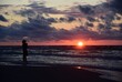 Walking on the beach by the Baltic Sea. Silhouette of a person