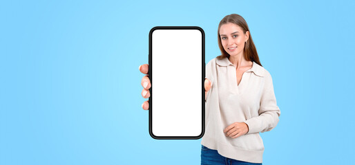 Young woman showing phone with blank screen