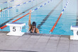 Swimmer celebrates victory at the poolside, with copy space