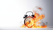A burning alarm clock on a white background - a symbol of time pressure, deadlines or deadline stress. The flames on the alarm clock indicate a hectic pace, haste and the pressure to complete a task.