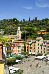 Wall Mural - High-angle view of the famous small square (Piazzetta) of Portofino, renowned tourist destination on the Italian Riviera, in summer, Genoa, Liguria, Italy