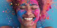 Happy Young Indian Woman With Colorful Holi Powder Smiling Surrounded By Paint Particles