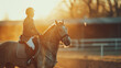 Cinematic shot of young male horsemanship master dressed in a professional apparel is practicing exercises for competition of horse racing and dressage on a riding hall