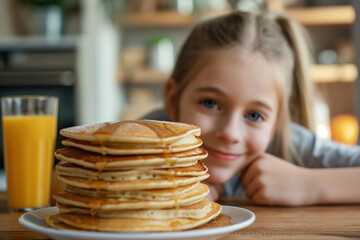 Young girl smiling at a delicious stack of pancakes, ideal for family and food themes.