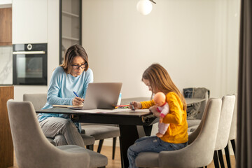 Smiling young mother working at home