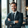 © Natasha - Portrait of successful businessman inside office in business suit, man with crossed arms smiling and looking at camera, experienced financier boss near window, investor