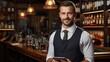 © Vilaysack - A professional bartender holding a tablet in a well-stocked bar, ready to offer recommendations with a friendly smile