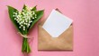 white flowers lily of the valley convallaria may bells may lily postal envelope with paper card note with space for text on a pink background top view flat lay spring decoration