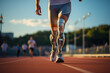 A man with a bionic prosthetic leg runs along the stadium track. Training, competitions, Paralympic games.