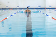 © Wavebreak Media - Caucasian female athlete swimmer swimming laps in a pool
