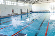 © Wavebreak Media - An indoor swimming pool awaits swimmers, with copy space