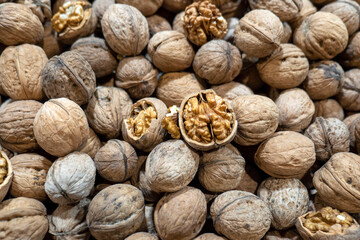 dried walnuts in shell for sale in the market, close-up shelled walnuts,