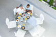 © Wavebreak Media - Senior biracial couple enjoys breakfast outdoors, with copy space
