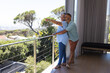 © Wavebreak Media - Senior biracial couple enjoys a scenic view from a balcony with copy space