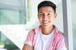 © Wavebreak Media - A young Asian man smiles brightly, with copy space