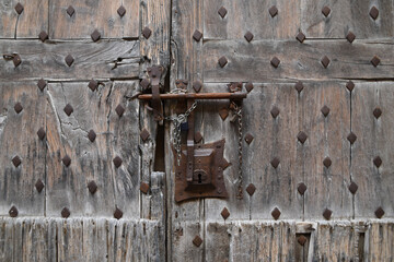 An old iron lock on the old wooden door