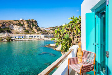 Wall Mural - Chair on terrace of typical Greek house and view of Rema beach in beautiful sea bay, Kimolos island, Cyclades, Greece