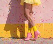 © Pastel King - Fashionable pastel vintage concept of women's footwear, autumn shoes, legs on which pastel confetti falls from the party.