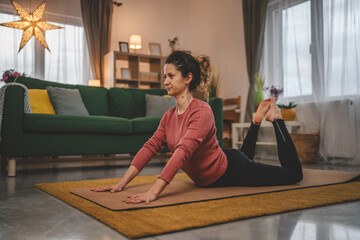 Woman caucasian female practice yoga on mat in living room at home