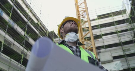 Wall Mural - Architect, man and blueprint paper in city, construction site and thinking of industrial development. Document, design and engineer with floor plan, building infrastructure and reading in low angle