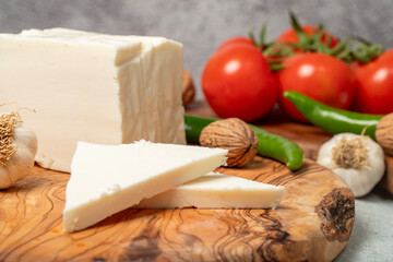 Full fat cow cheese. Fresh feta cheese on cutting board. Close up